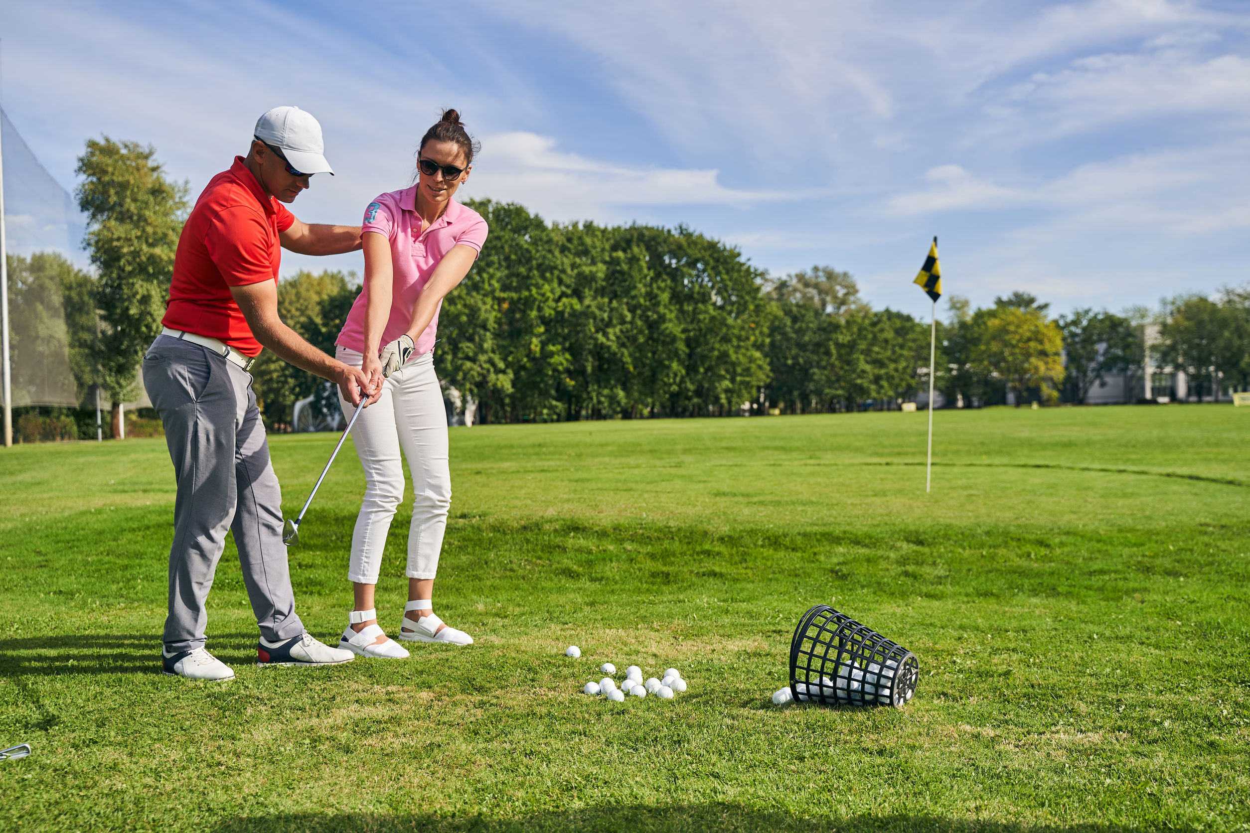 Golf instructor teaching a student on the course